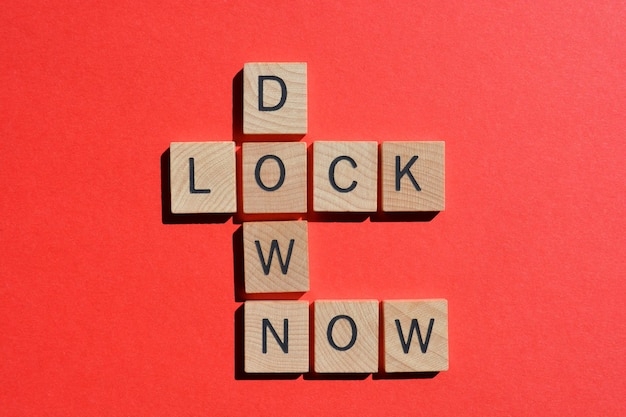 Premium Photo Lock down now crossword on red avoid the spread